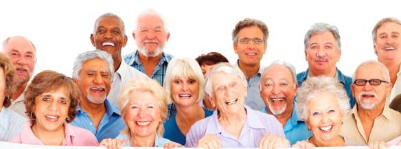 Group of happy retired people behind an empty billboard on white