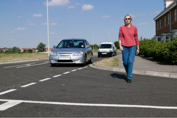 pedestrian-walking-across-the-road-at-a-junction